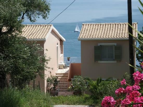 a house with the ocean in the background at Maria Corfu Loustri in Corfu Town