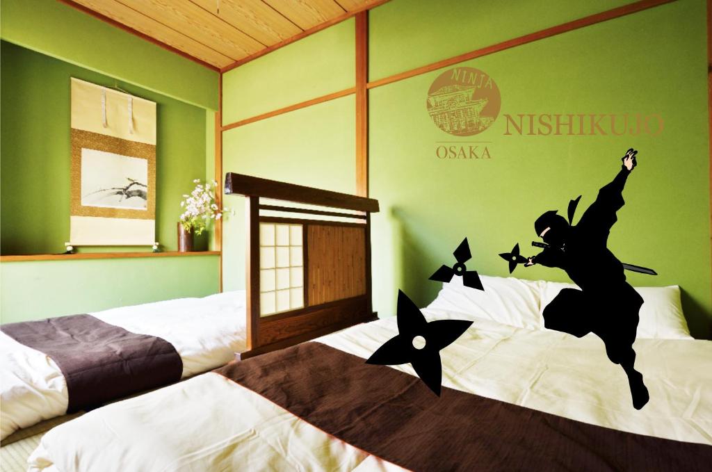 a bedroom with two beds with a witch on the wall at City Hotel Universal Studios Japan in Osaka