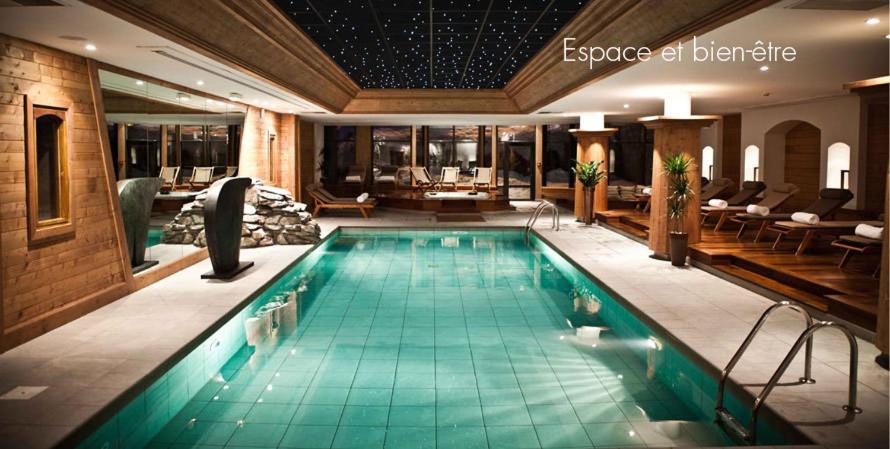 a large swimming pool in a hotel room at Hôtel Les Barmes De l'Ours in Val-d'Isère