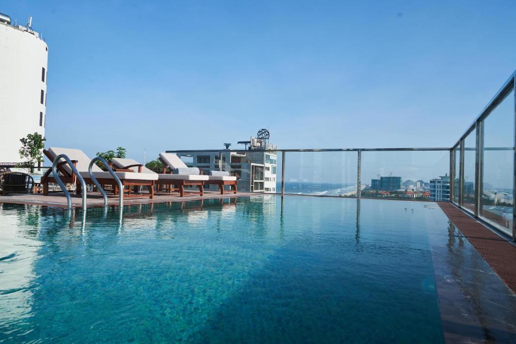 a large swimming pool on top of a building at Sofiana My Khe Hotel & Spa- Rooftop Pool Bar in Danang