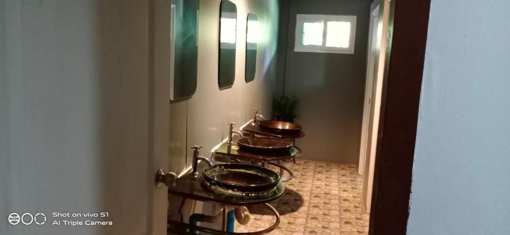 a bathroom with three copper sinks in a room at Decho Hostel in Ko Lipe
