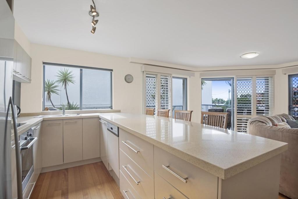 a kitchen with a large island in the middle of a room at Breakwater Views by Kingscliff Accommodation in Cabarita Beach