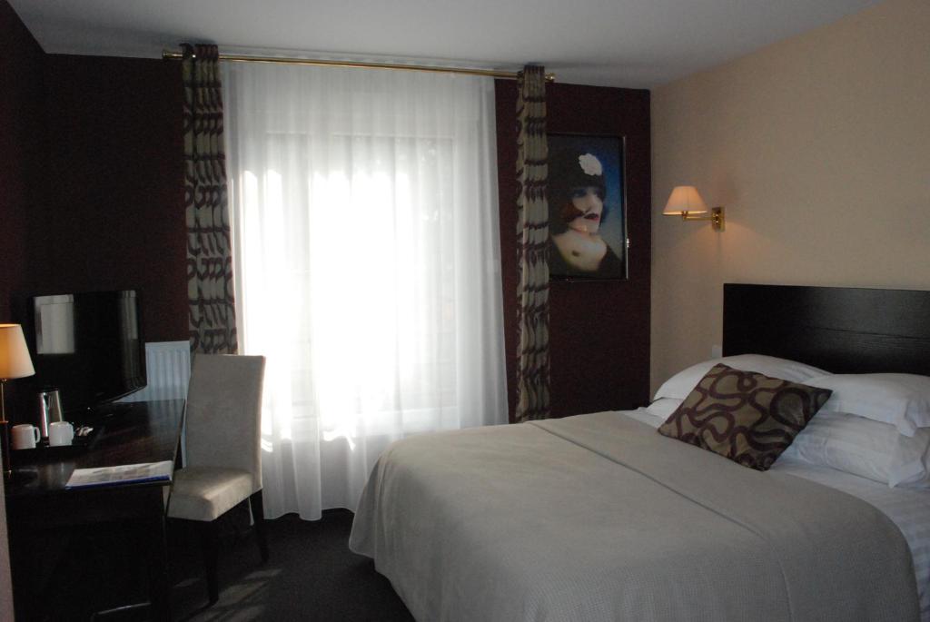 Postel nebo postele na pokoji v ubytování Hôtel Ariane & SPA