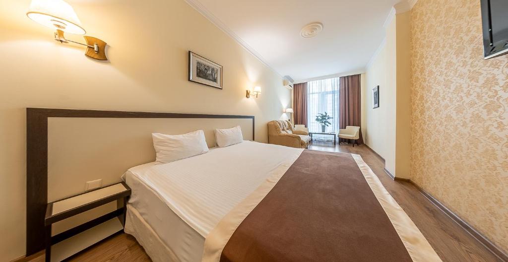 Postel nebo postele na pokoji v ubytování Corona Hotel & Apartments