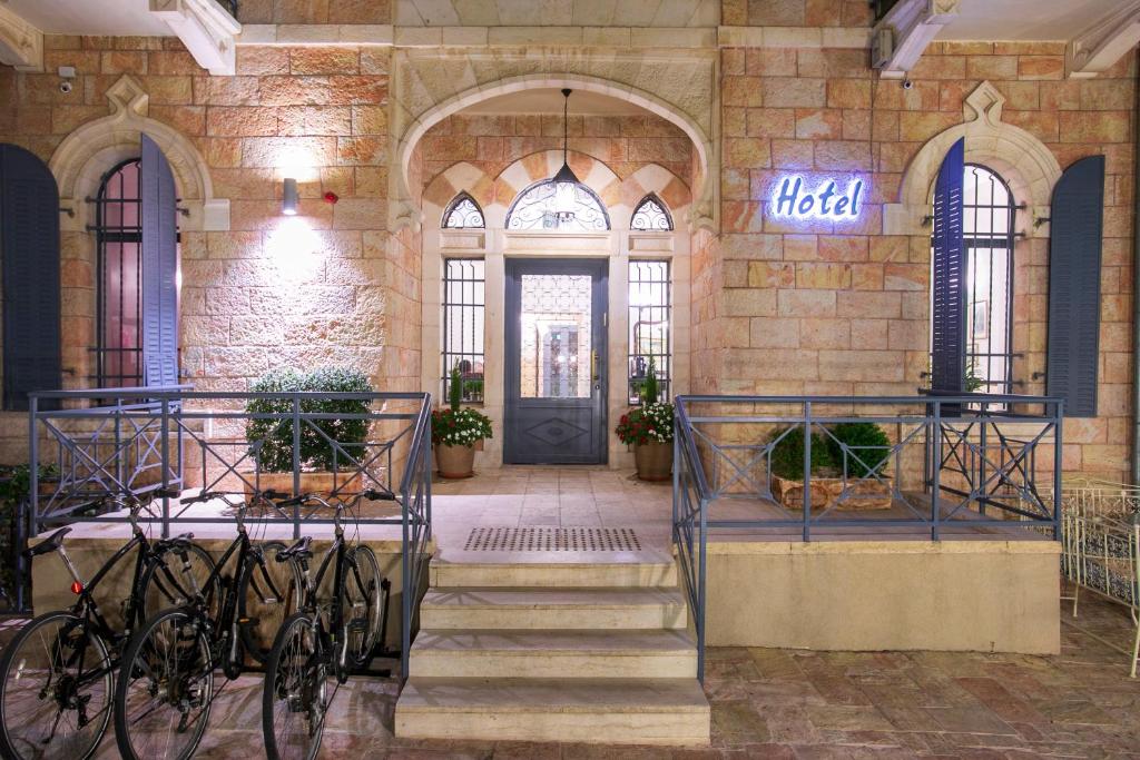 a building with bikes parked in front of a door at Villa Brown Moshava - a member of Brown Hotels in Jerusalem