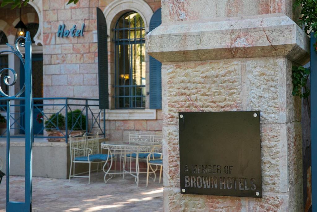 a sign on the side of a corner of a brown hotel at Villa Brown Moshava - a member of Brown Hotels in Jerusalem