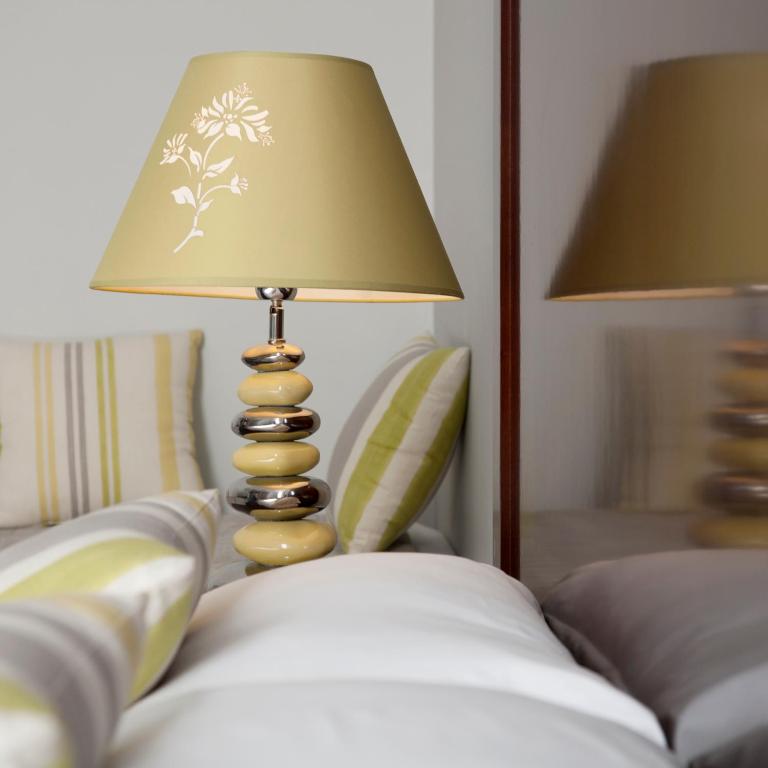 Postel nebo postele na pokoji v ubytování Hôtel Relais Acropolis