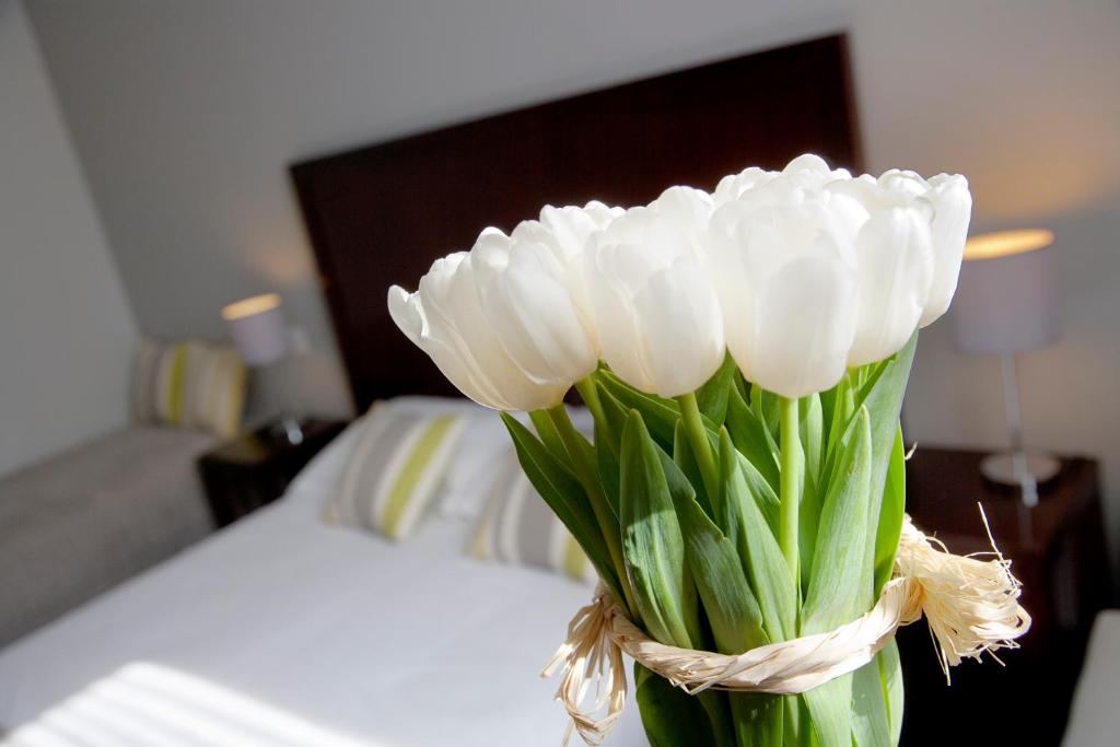 Postel nebo postele na pokoji v ubytování Hôtel Relais Acropolis