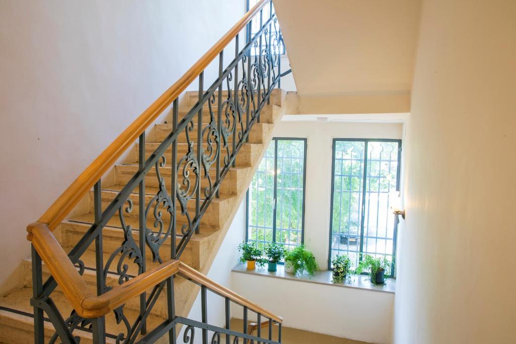 a staircase in a house with potted plants at Villa Brown Moshava - a member of Brown Hotels in Jerusalem