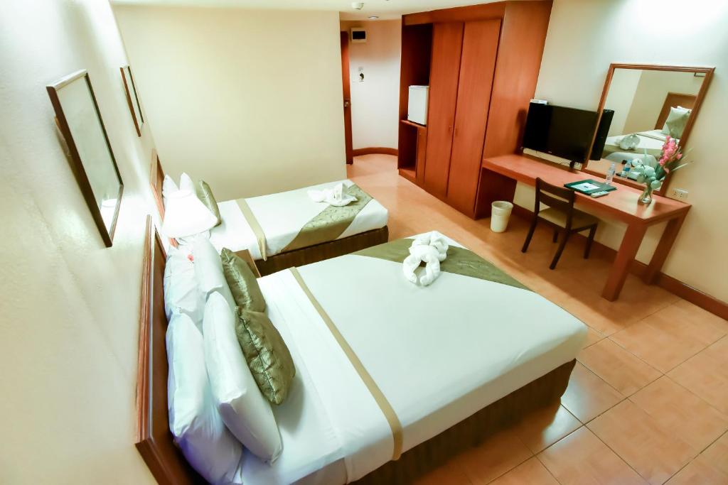 Postel nebo postele na pokoji v ubytování Rajah Park Hotel by Hiverooms