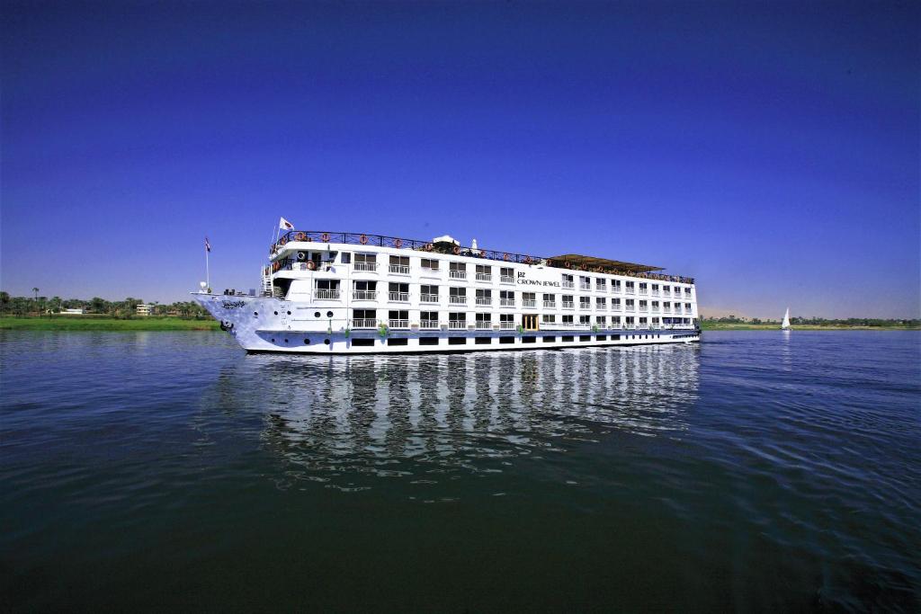 a large white cruise ship on the water at Jaz Crown Jewel Nile Cruise - Every Saturday from Luxor for 07 & 04 Nights - Every Wednesday From Aswan for 03 Nights in Luxor