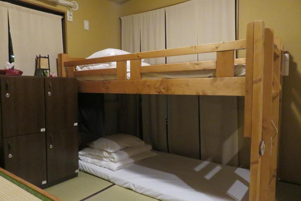 Postel nebo postele na pokoji v ubytování Guest House Nakaima