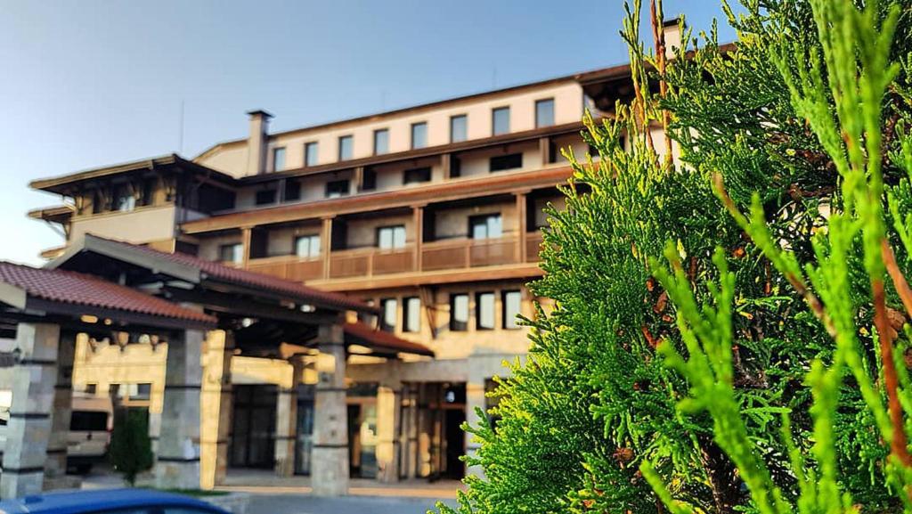 a large building in front of a building at Trinity Residence Bansko in Bansko