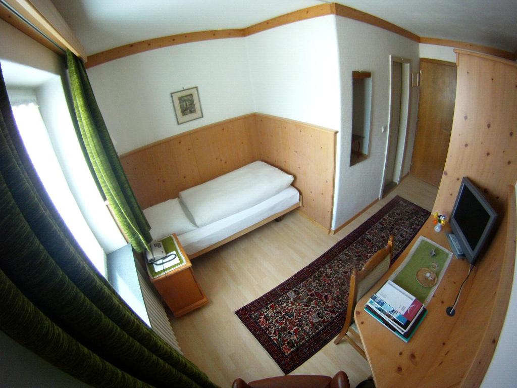 an overhead view of a room with a couch and a television at Hotel Bären in St. Moritz