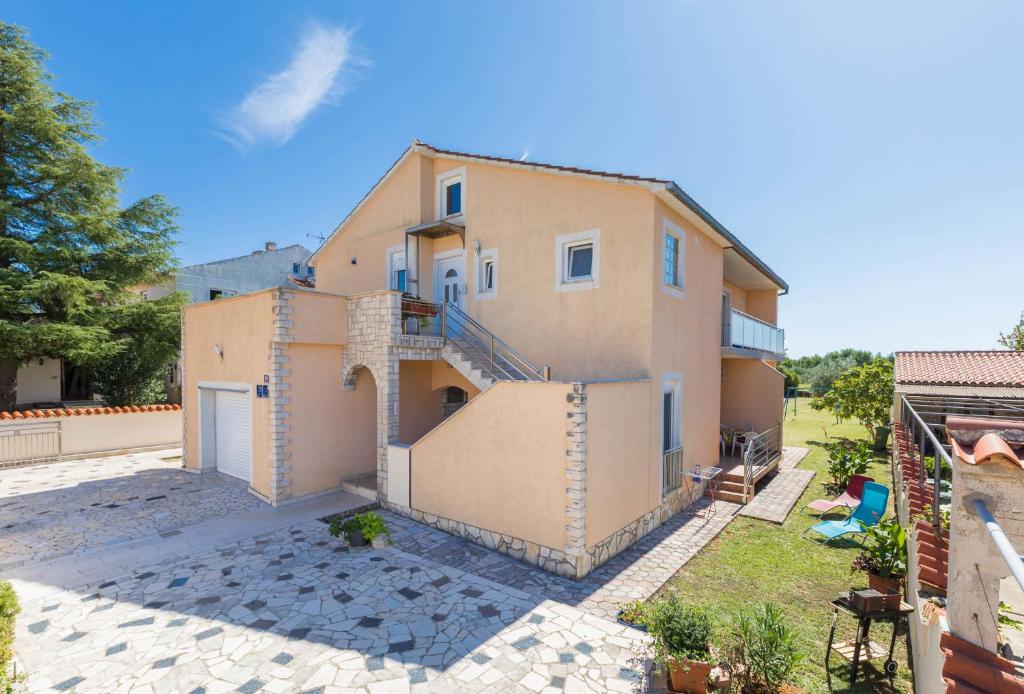 an exterior view of a house with a patio at Apartments Ankica Blue in Peroj