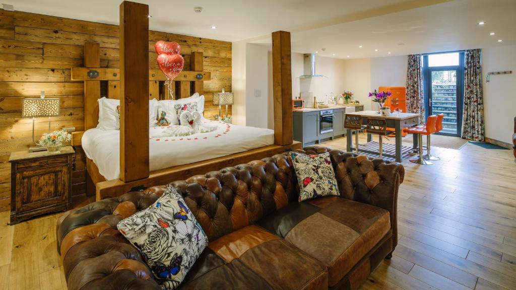 a living room with a couch and a bed at Grange Boutique Hotel in Grange Over Sands