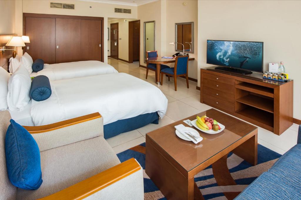 A bed or beds in a room at Al Rawda Arjaan by Rotana, Abu Dhabi