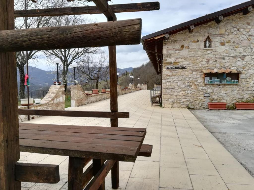 a wooden bench sitting in front of a building at Agriturismo le cascine in Castel di Tora