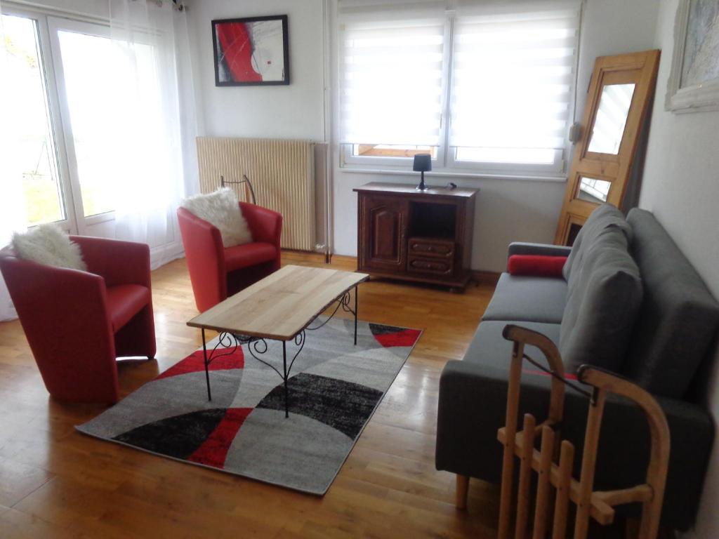 a living room with a couch and a table at GITE DES BOULEAUX in Maîche