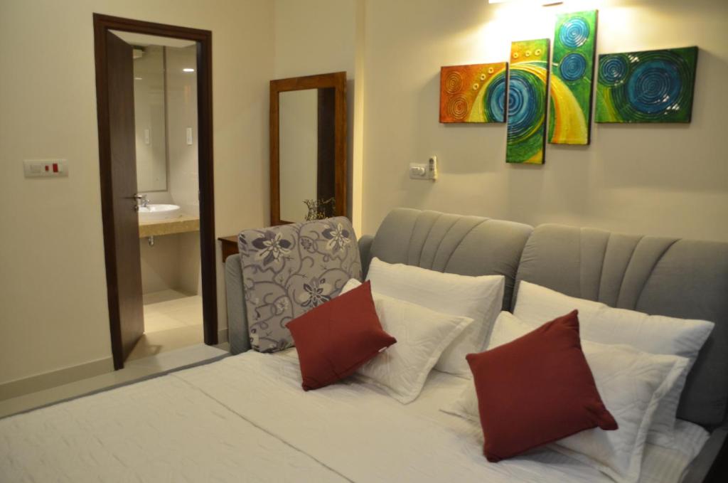 a living room with a couch with pillows at Atrium - ICONIC APARTMENT in Sri Jayewardenepura Kotte