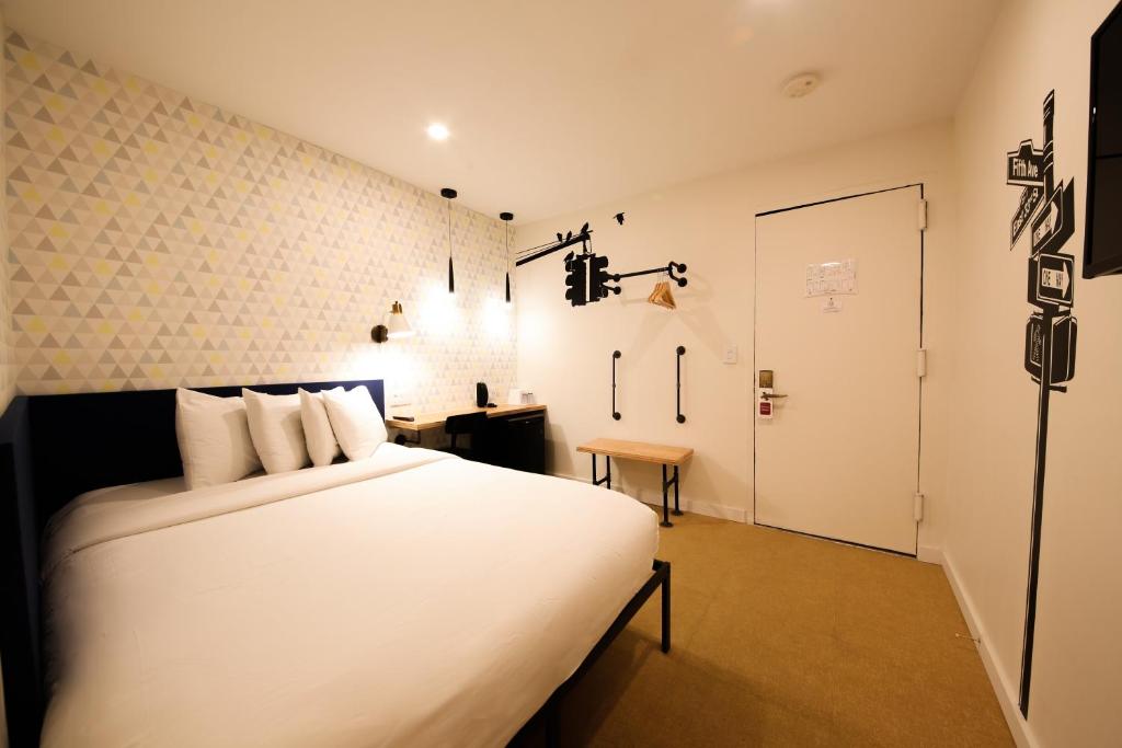 a bedroom with a large white bed in a room at Doxie Hotel in New York