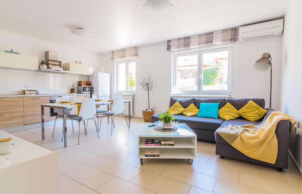 a living room with a couch and a table at Apartments Nicole in Pula