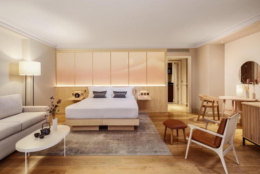 a bedroom with a bed and a living room at The Prince Akatoki London in London