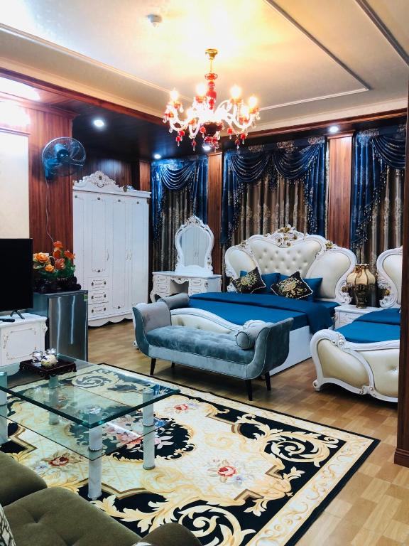 a living room filled with furniture and a chandelier at Elisa Hotel in Ninh Binh