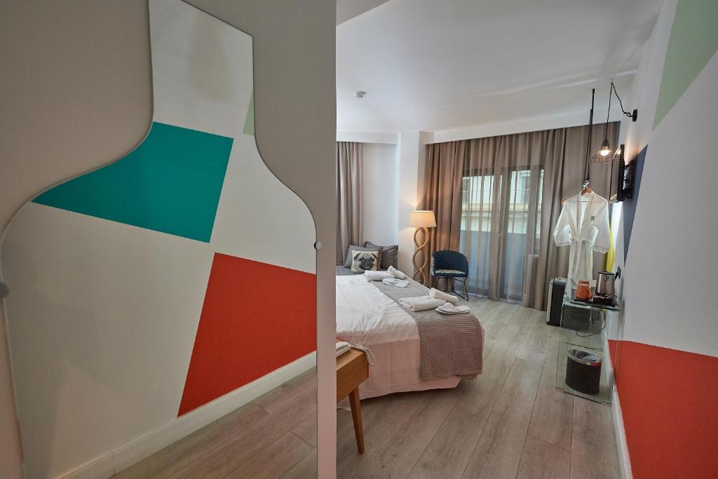 Postel nebo postele na pokoji v ubytování Blue Bottle Boutique Hotel