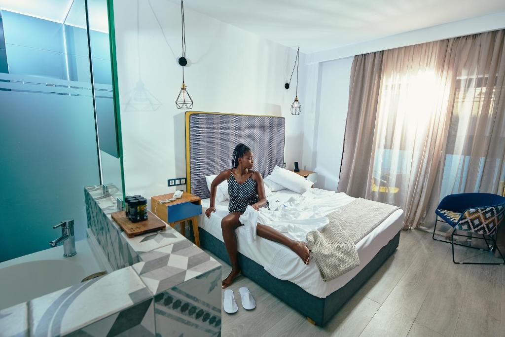 Postel nebo postele na pokoji v ubytování Blue Bottle Boutique Hotel