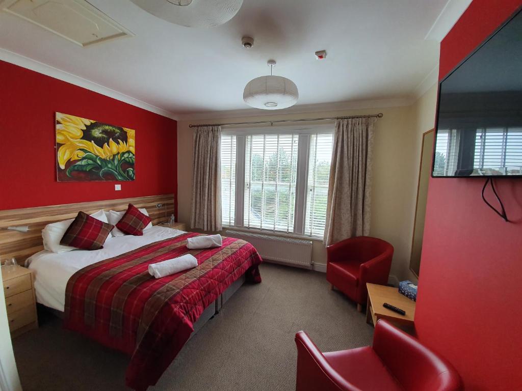 a hotel room with two beds and two lamps at The Flowerpot in Derby