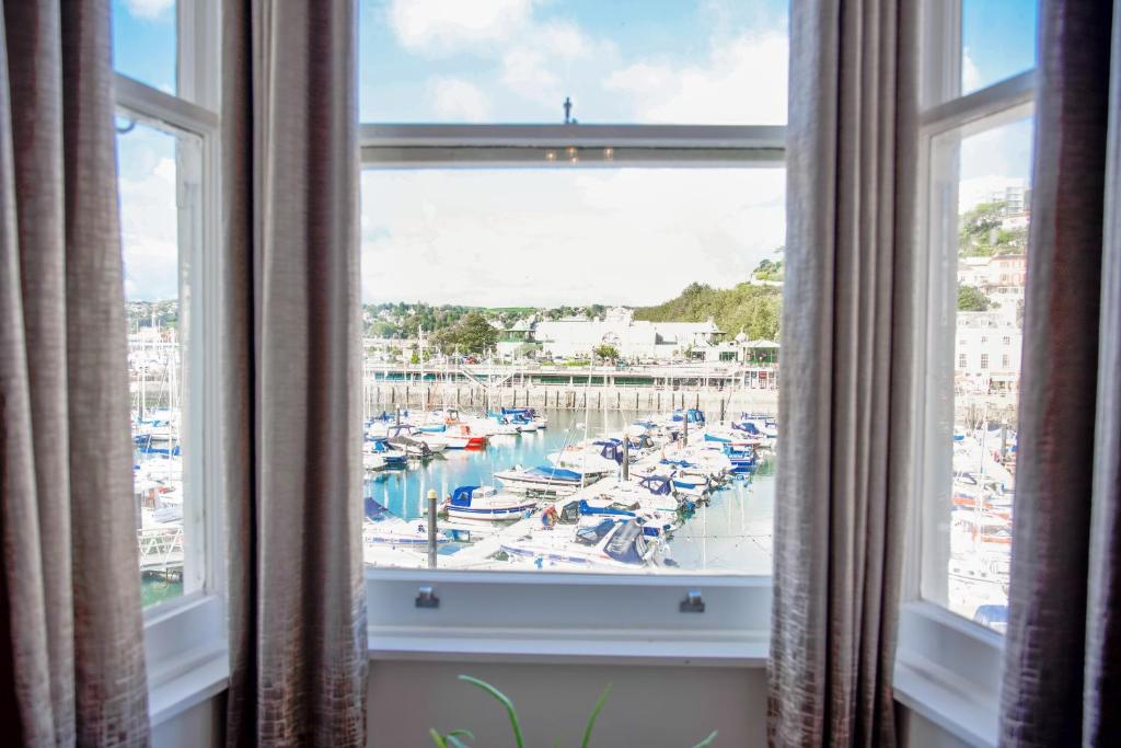 a window with a view of a marina at Victoria Apartments in Torquay