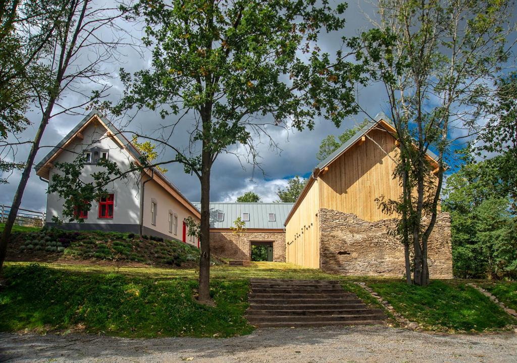 a house with stairs leading up to it at Samota Hojšín in Neustupov