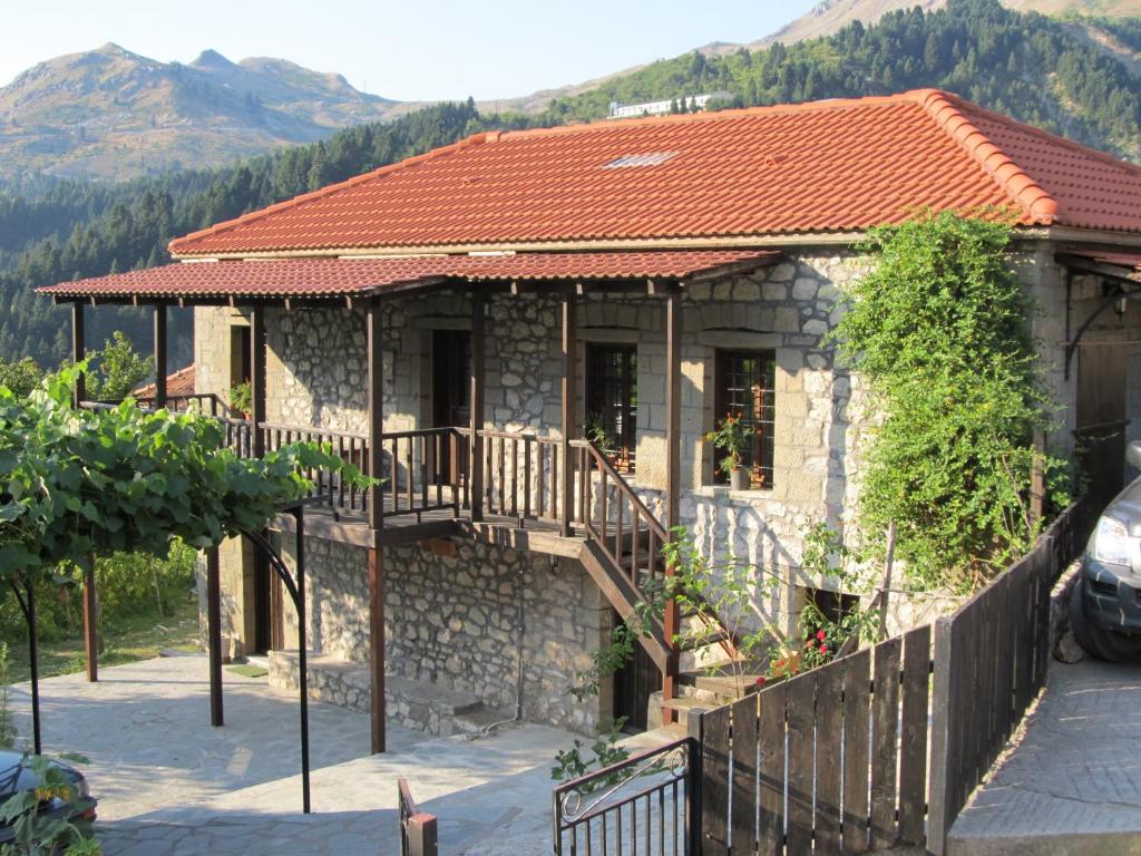 a stone house with a balcony and a fence at Guesthouse Ventista-Ξενώνας in Theodóriana