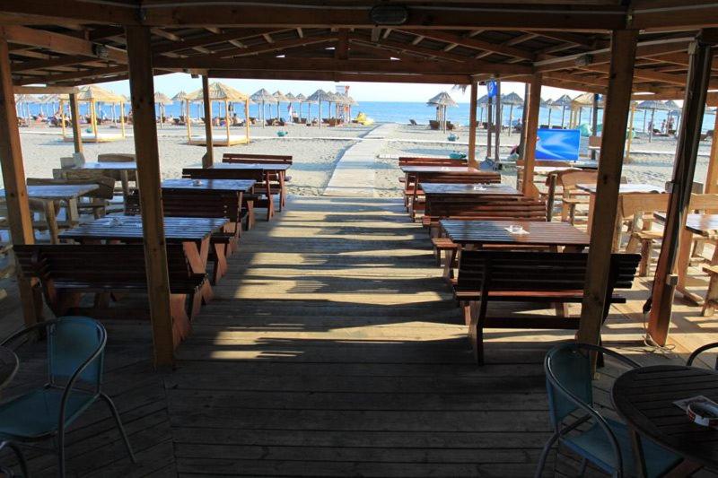 a row of tables and benches on the beach at 500 Meters from Grate Beach, App 1 in Ulcinj
