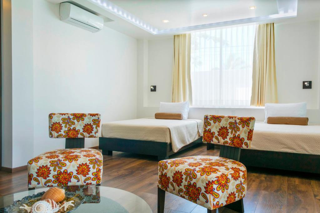 Postel nebo postele na pokoji v ubytování Ikala Galapagos Hotel
