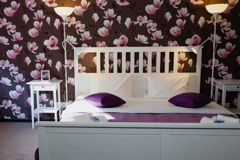 a bedroom with a white bed with purple pillows at Sleep House Рязань in Ryazan