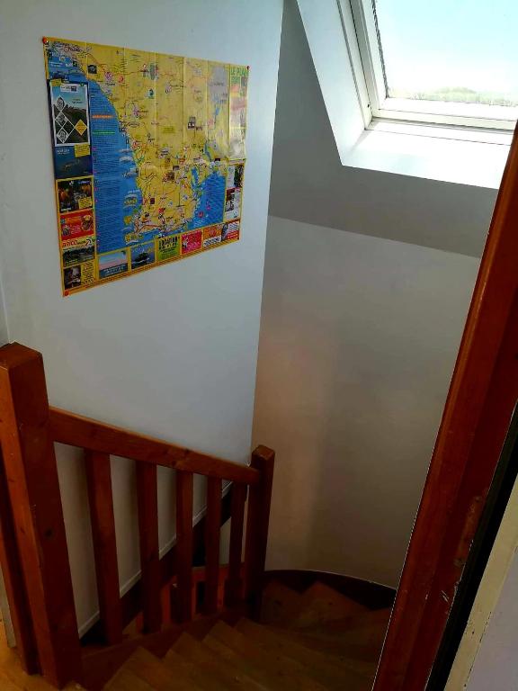 a picture of a map on a wall next to a staircase at Ty Biz in Saint-Jean-Trolimon
