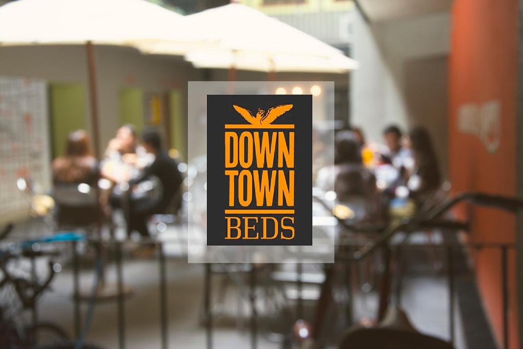 a sign that says down town beds in a restaurant at Downtown Beds in Mexico City
