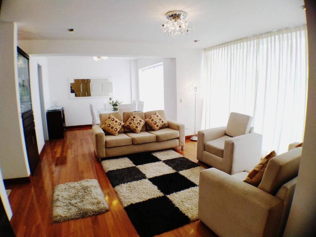 a living room with two couches and a rug at Beautiful Apartment Financial Zone-Fully Furnished in Lima