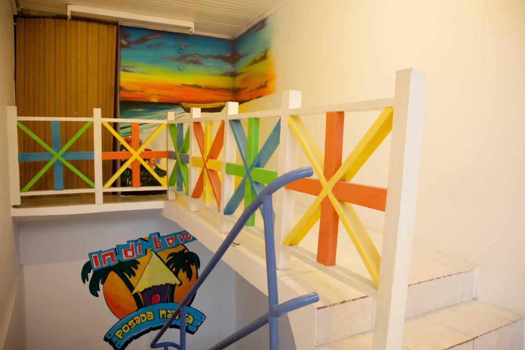 a room with a staircase with a painting on the wall at Apartamentos Turísticos In Di Town in San Andrés