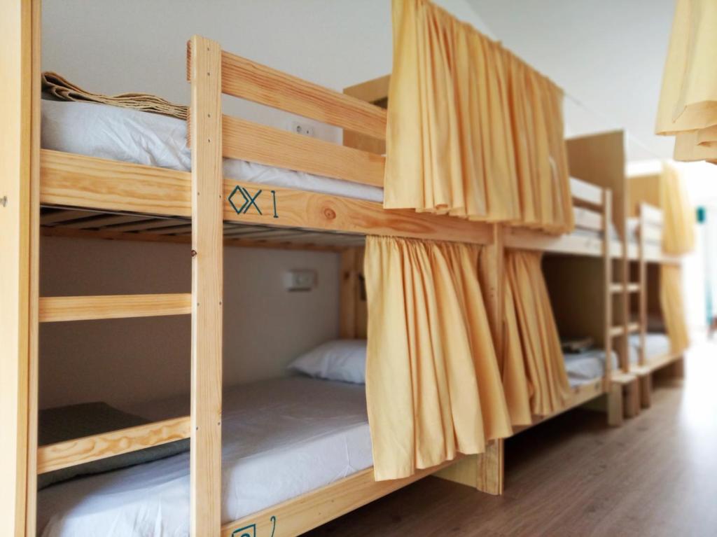 a couple of bunk beds in a room at Albergue O Peirao in A Guarda