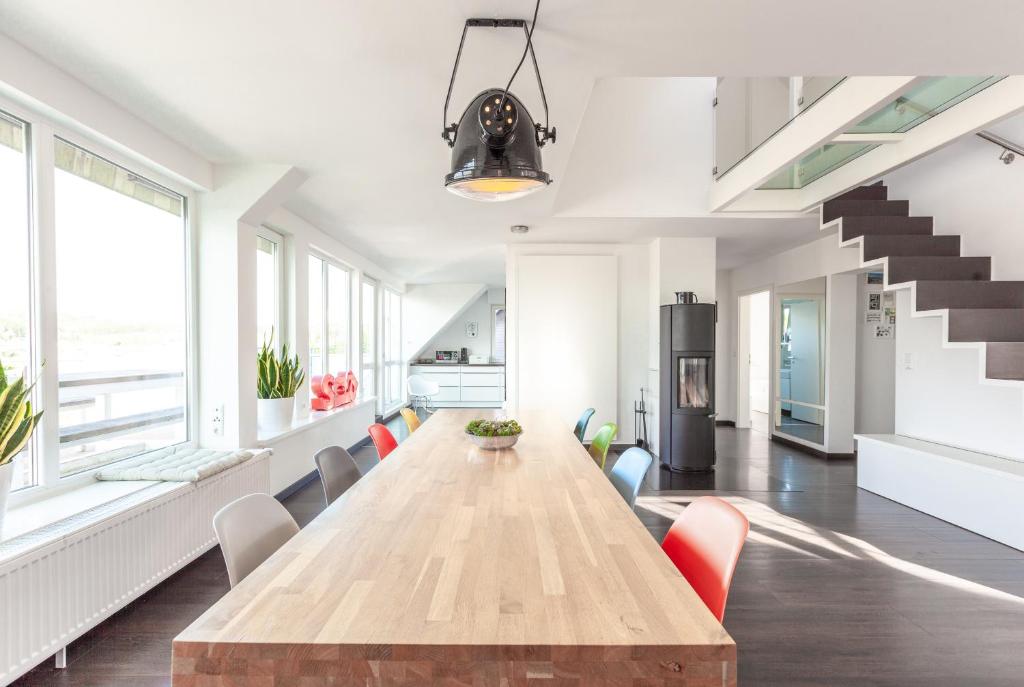 a large dining room with a wooden table and chairs at Architektenwohnungen mit Panoramablick bei Köln in Lindlar