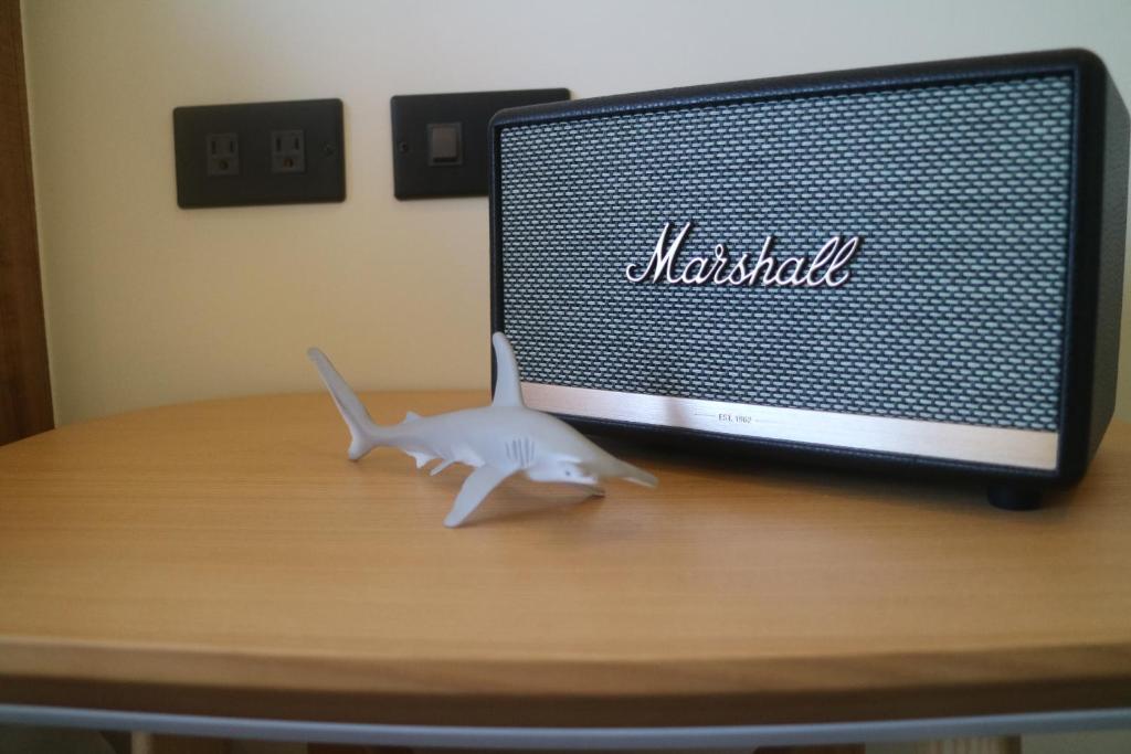 a shark toy sitting on a desk in front of a computer monitor at Shark B&B in Hengchun