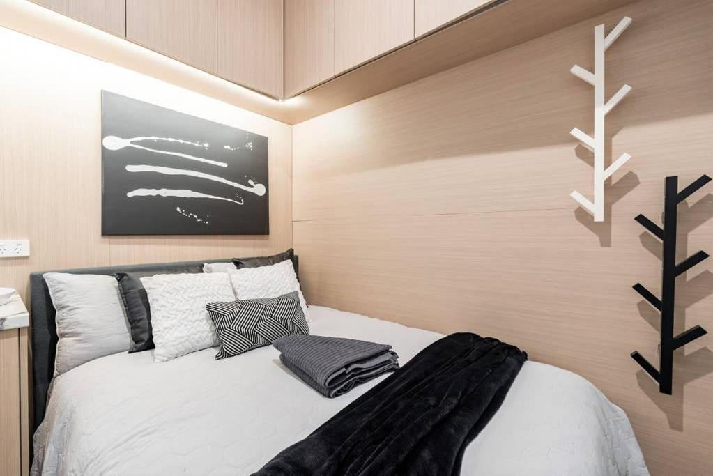 a bedroom with a white bed and a black and white wall at 1 Private Double Bed In Sydney CBD Near Train UTS DarlingHar&ICC&C hinatown - ROOM ONLY in Sydney