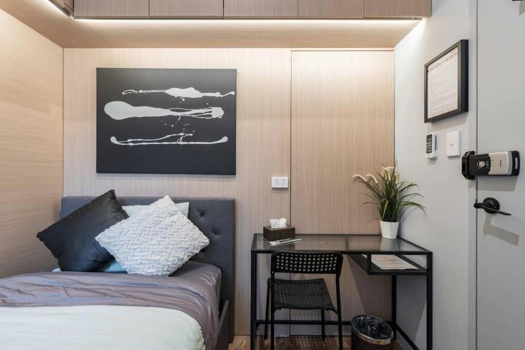 a bedroom with a bed and a desk with a chair at 1 Private King Single Bed In Sydney CBD Near Train UTS DarlingHar&ICC&C hinatown - ROOM ONLY in Sydney