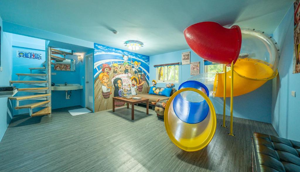 a childs room with a slide and a play area at Julie&#39;s Garden, Cingjing - Fon Chin Homestay in Ren&#39;ai