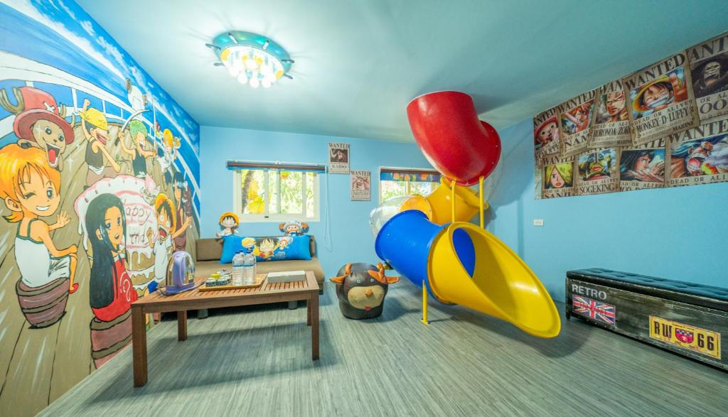 a childs room with a play area with a slide at Julie&#39;s Garden, Cingjing - Fon Chin Homestay in Ren&#39;ai