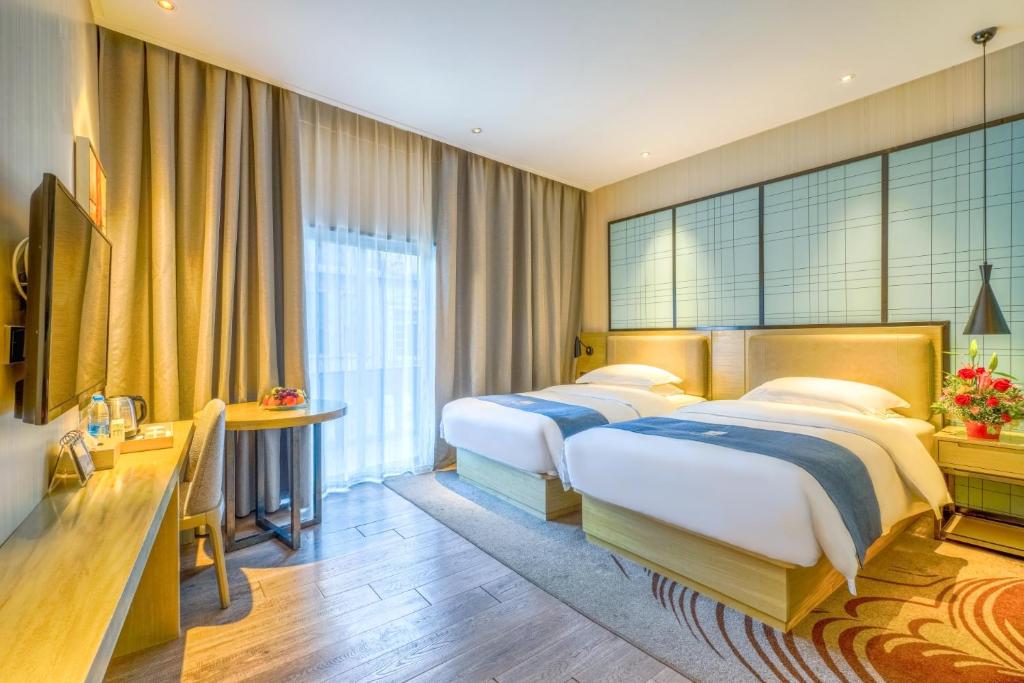 Postel nebo postele na pokoji v ubytování Echarm Hotel - Xiamen Zhongshan Road Pedestrian Street Branch