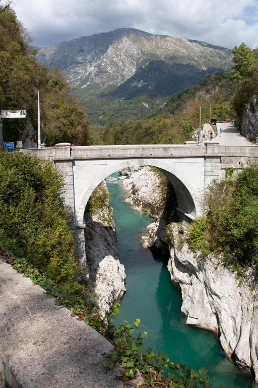 a bridge over a river with a mountain in the background at Apartments Bobi in Tolmin